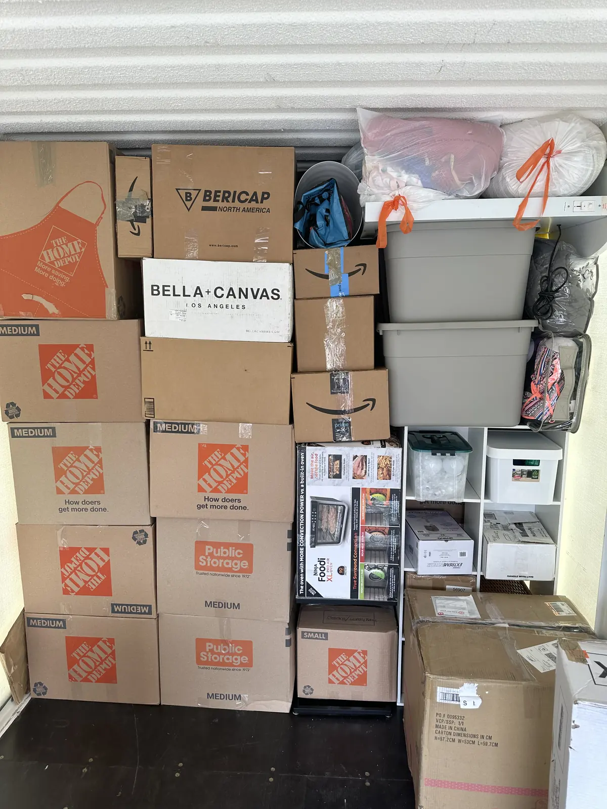 Cardboard boxes and plastic storage bins stacked together in a storage space