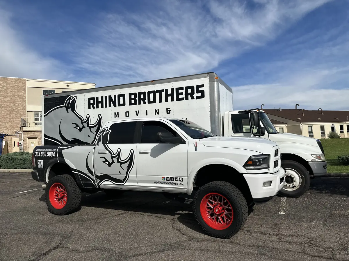 Rhino Brothers branded pickup parked in front of a branded moving truck
