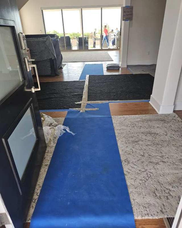 Protective floor runners laid through a home's entryway on moving day