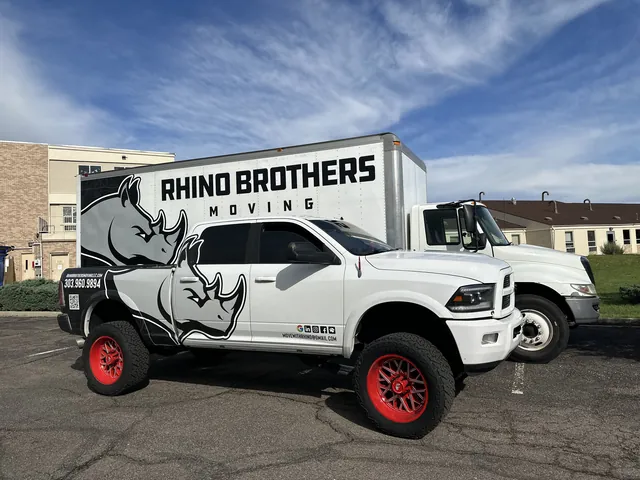 Rhino Brothers branded pickup and moving truck under a Colorado sky